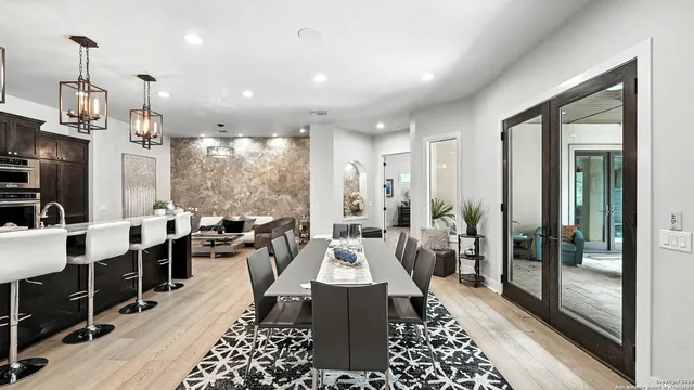 a large room with lots of tables a chandelier and couches