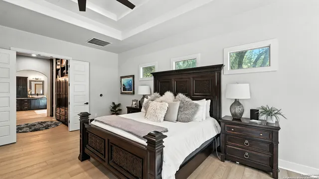 a bedroom with a bed and wooden floor