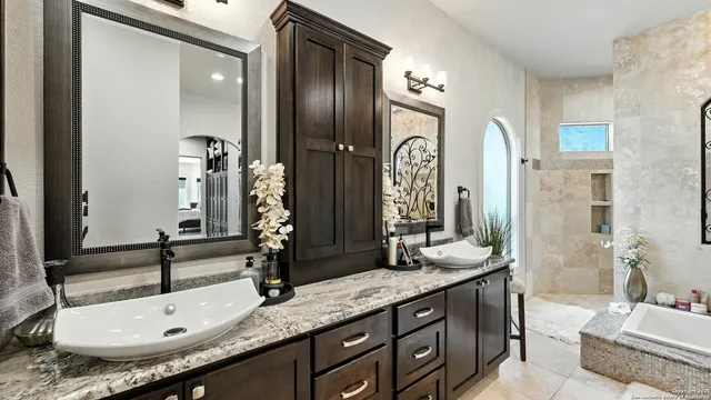 a bathroom with double vanity sinks and a mirror