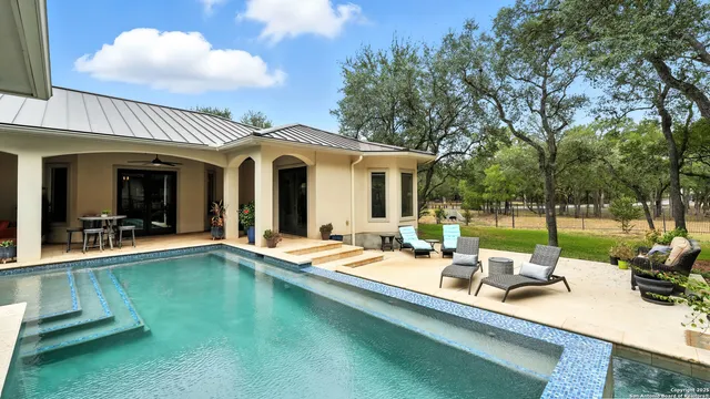 a group of people sitting in front of a house