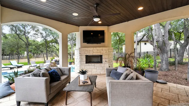 a living room with furniture a large window and a fireplace