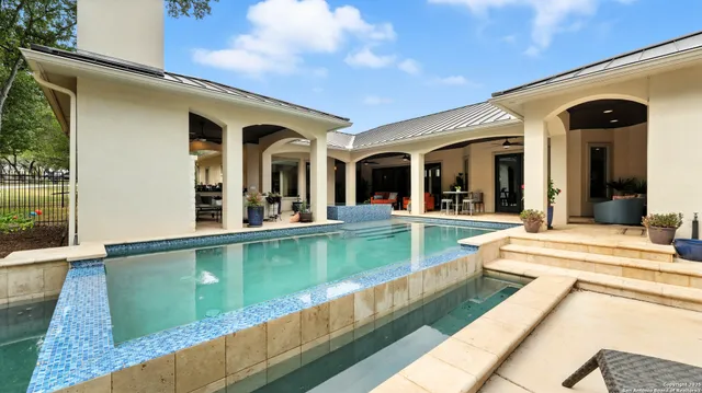 a view of a house with swimming pool and furniture