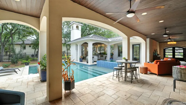 a view of a patio with dining table and chairs