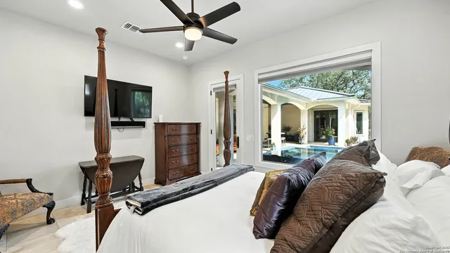 a bed room with a bed window and a flat screen tv