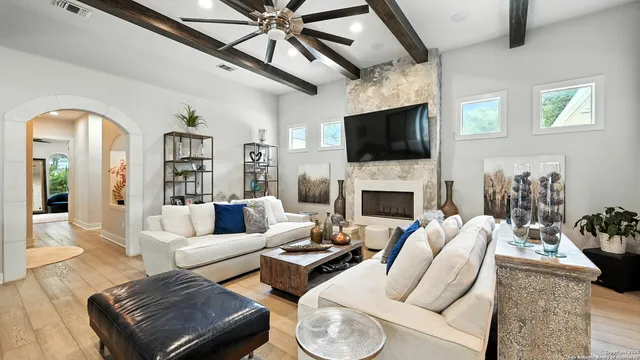 a living room with furniture a flat screen tv and a fireplace