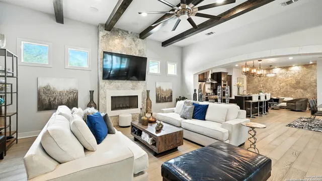 a living room with furniture a flat screen tv and a fireplace