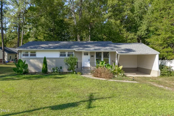 a front view of house with yard and green space
