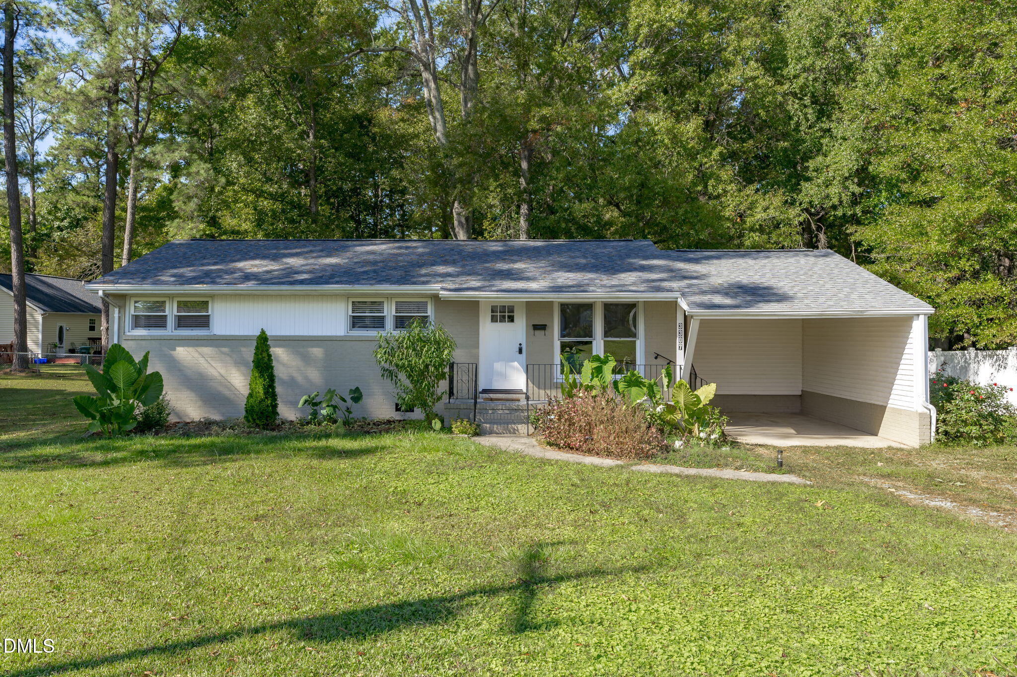 a front view of house with yard and green space