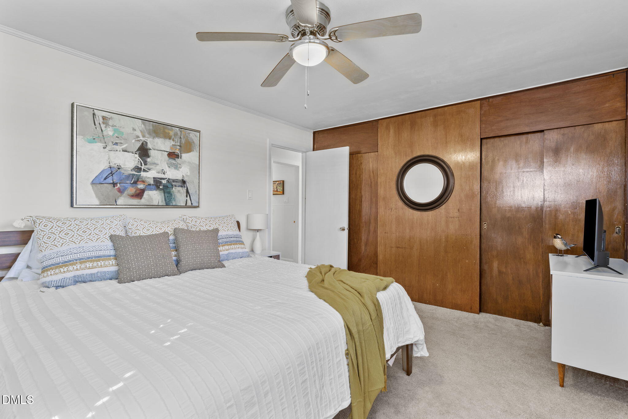 3307 Winston Road Durham, NC 27704 - Photo 14 of 22 a bedroom with a large bed and a chandelier