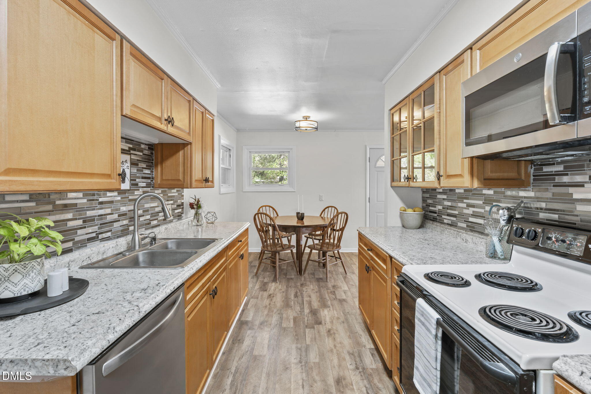 3307 Winston Road Durham, NC 27704 - Photo 5 of 22 a kitchen with granite countertop lots of counter top space a sink and stainless steel appliances