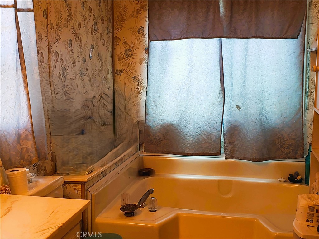 21217 Washington Avenue, Unit 32 Walnut, CA 91789 - Photo 12 of 15 a bathroom with a sink and a tub