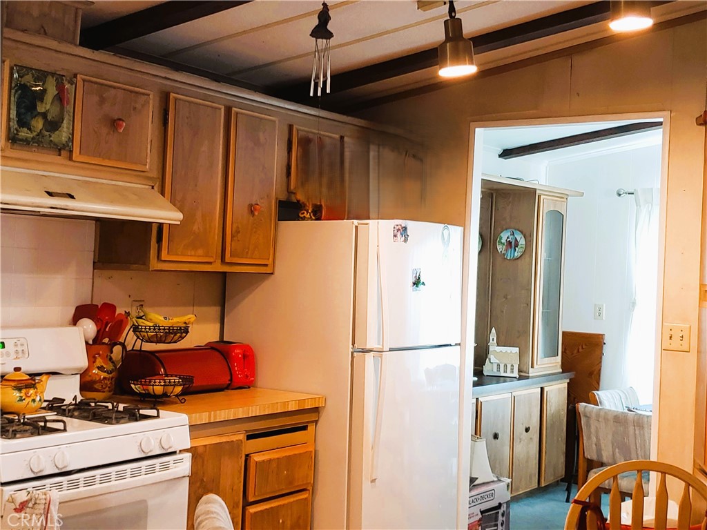 21217 Washington Avenue, Unit 32 Walnut, CA 91789 - Photo 6 of 15 a kitchen with stainless steel appliances granite countertop a refrigerator and a stove top oven