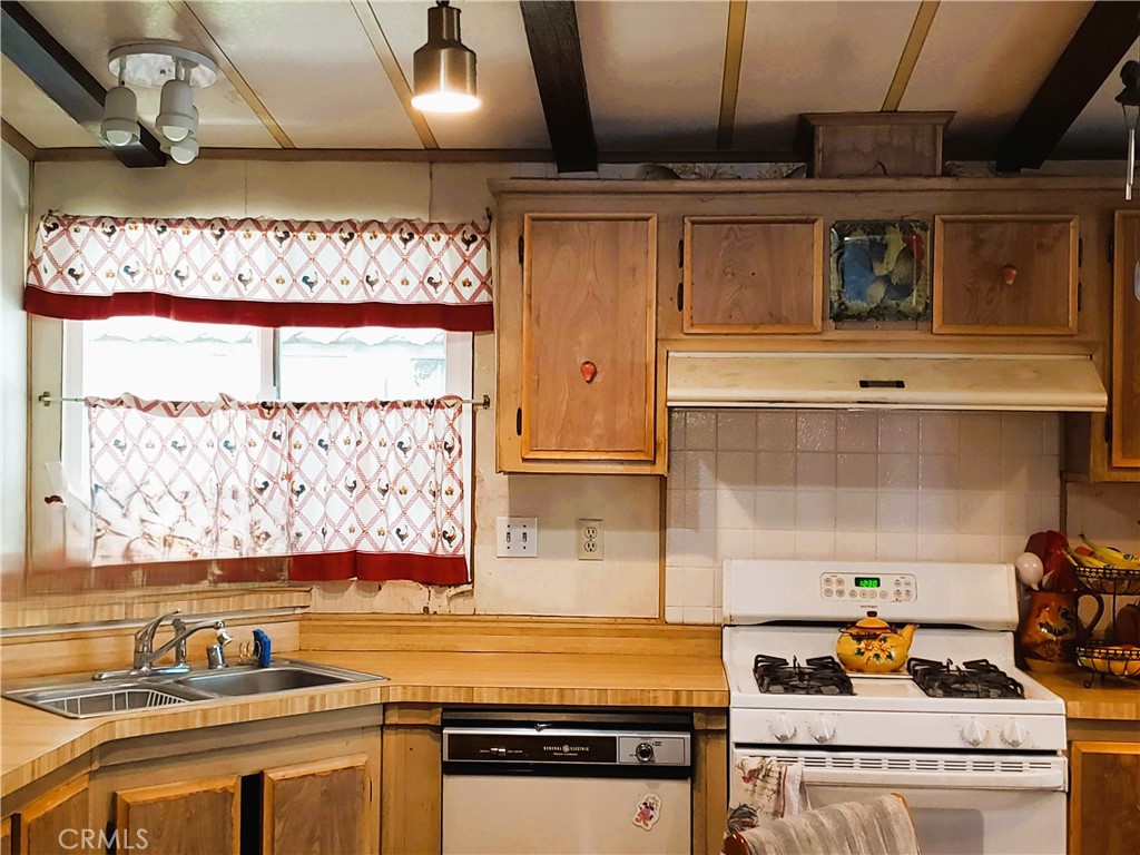 21217 Washington Avenue, Unit 32 Walnut, CA 91789 - Photo 7 of 15 a kitchen with stainless steel appliances granite countertop a stove and a sink