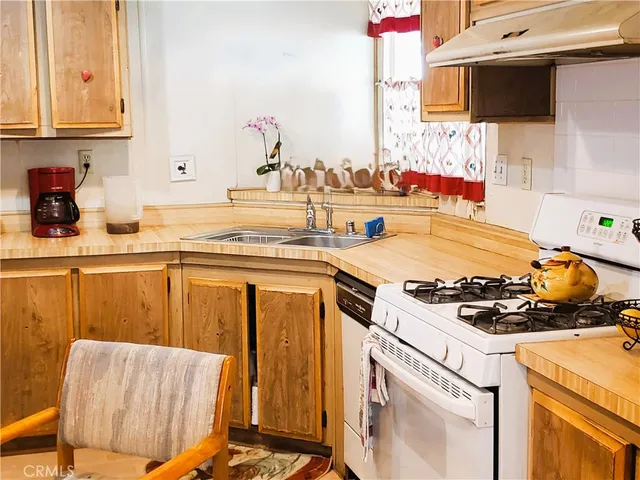 a kitchen with a stove a sink and a microwave