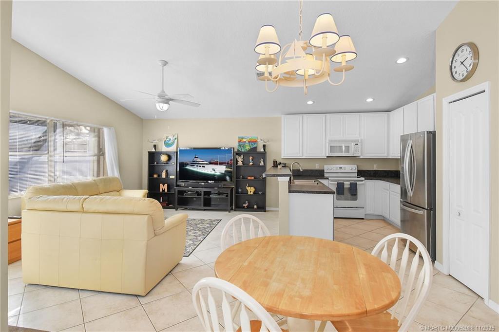 486 Northwest Sunflower Place Stuart, FL 34994 - Photo 11 of 42 a kitchen that has a lot of cabinets and refrigerator