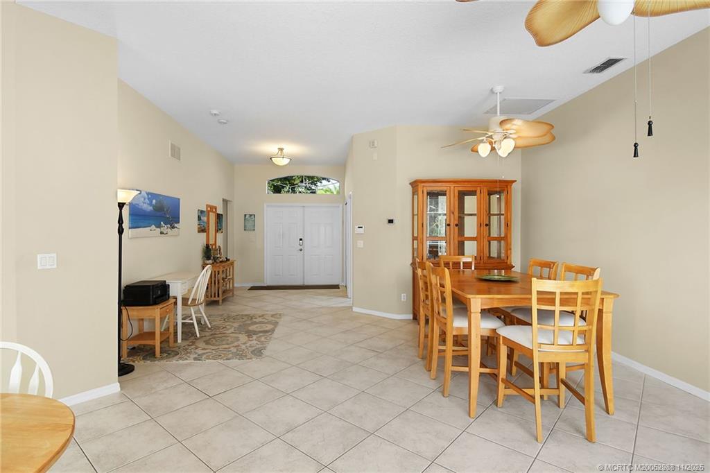 486 Northwest Sunflower Place Stuart, FL 34994 - Photo 12 of 42 a view of a dining room with furniture and a chandelier