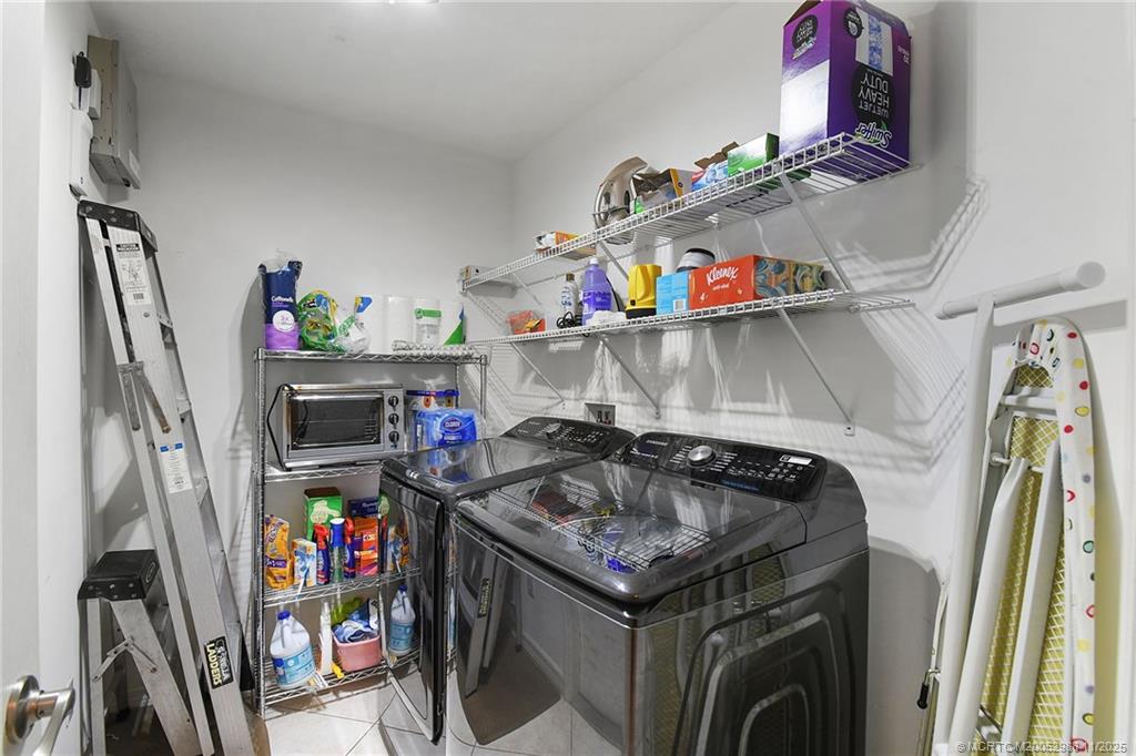486 Northwest Sunflower Place Stuart, FL 34994 - Photo 18 of 42 a utility room with dryer and washer