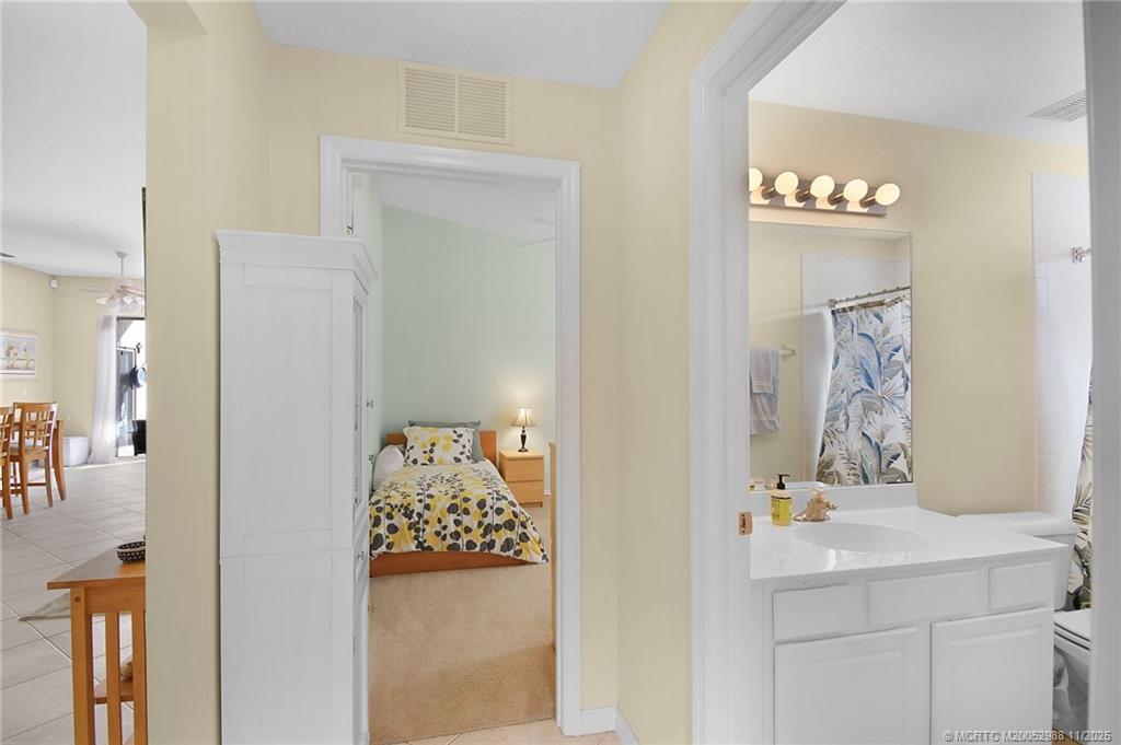 486 Northwest Sunflower Place Stuart, FL 34994 - Photo 21 of 42 a bathroom with a sink and a mirror