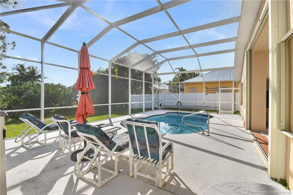 486 Northwest Sunflower Place Stuart, FL 34994 - Photo 32 of 42 a view of a patio with a table and chairs