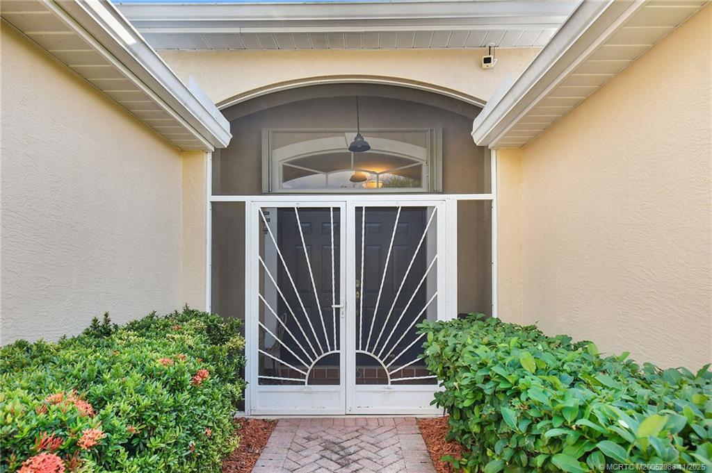 486 Northwest Sunflower Place Stuart, FL 34994 - Photo 4 of 42 a front view of a house with garden