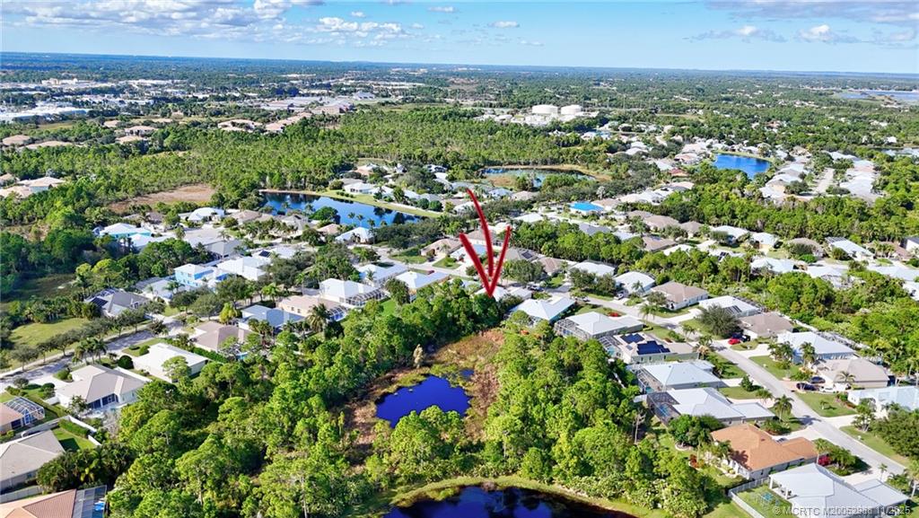 486 Northwest Sunflower Place Stuart, FL 34994 - Photo 42 of 42 an aerial view of residential houses with outdoor space and trees