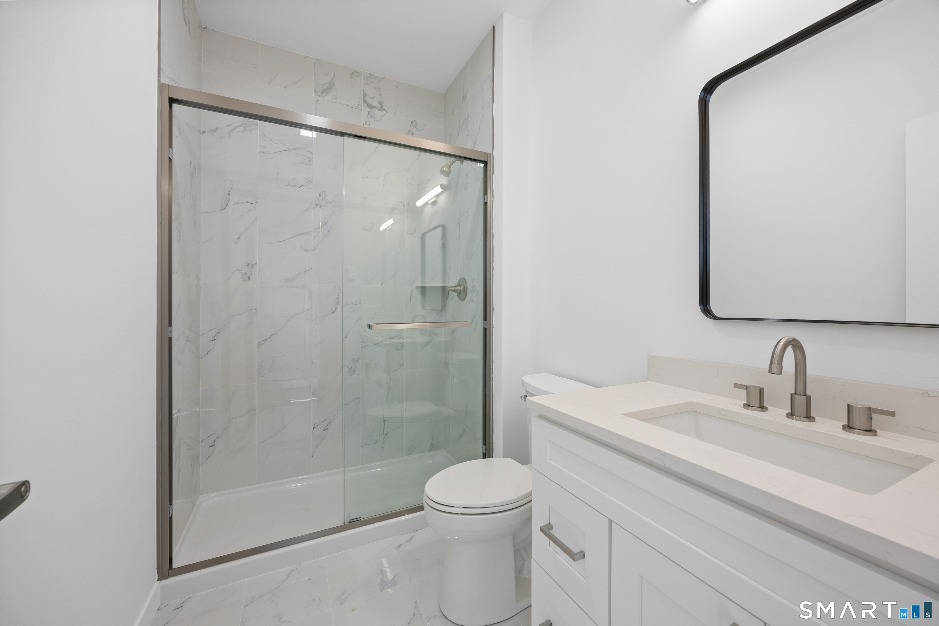 27 Village Road, Unit E Milford, CT 06460 - Photo 6 of 13 a bathroom with a sink toilet and shower