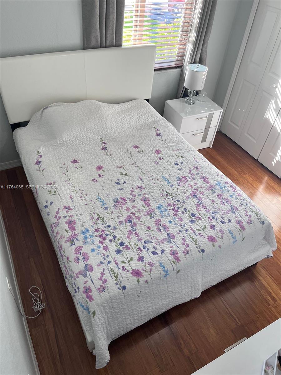 22937 Southwest 9th Avenue, Unit 1 Miami, FL 33170 - Photo 11 of 19 a bed sitting in a bedroom next to a window