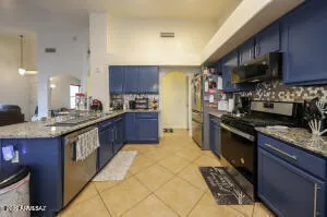 a large kitchen with stainless steel appliances granite countertop a stove a sink dishwasher and a refrigerator