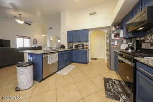 a kitchen with stainless steel appliances granite countertop a stove a sink and a refrigerator