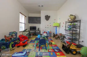 a play room with toys and a tv