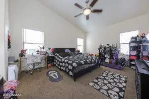a bedroom with bed and a chandelier
