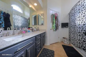 a bathroom with a double vanity sink and mirror