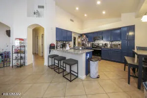 a kitchen with stainless steel appliances granite countertop a table and a sink