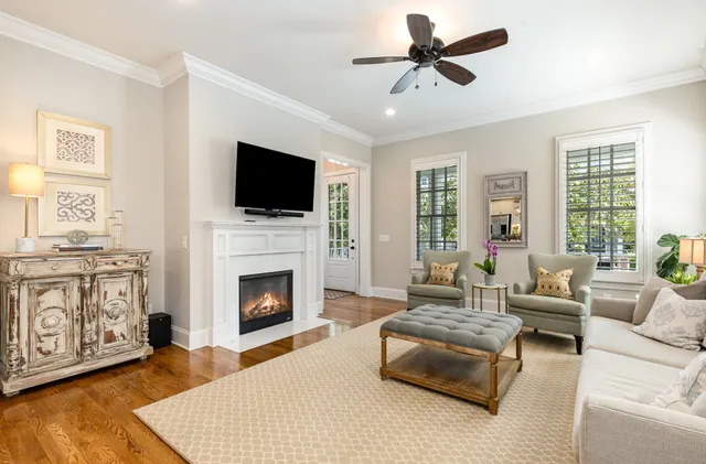 a living room with furniture fireplace and flat screen tv