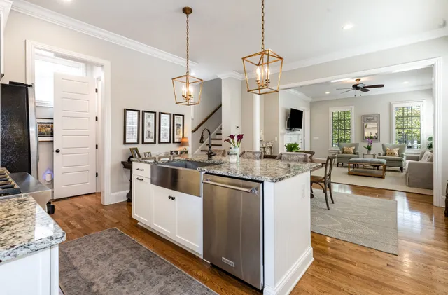 a kitchen with stainless steel appliances granite countertop a stove and cabinets