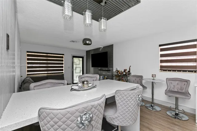 a dining room with furniture and wooden floor