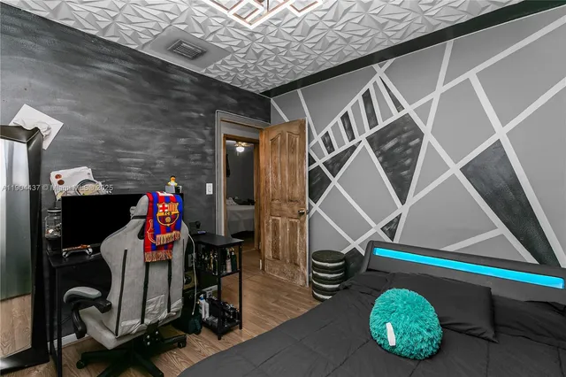 a view of gym equipment with wooden floor