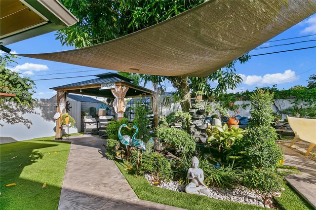 a view of a patio with table and chairs under an umbrella