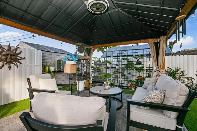 a view of outdoor dining space with furniture and outdoor kitchen