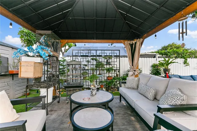 a building outdoor space with patio furniture and potted plants