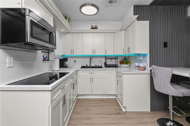 a kitchen with a sink a stove and cabinets