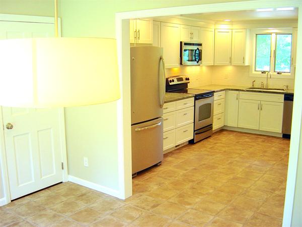 162 Nourse Road Bolton, MA 01740 - Photo 7 of 30 a kitchen with stainless steel appliances a refrigerator and cabinets