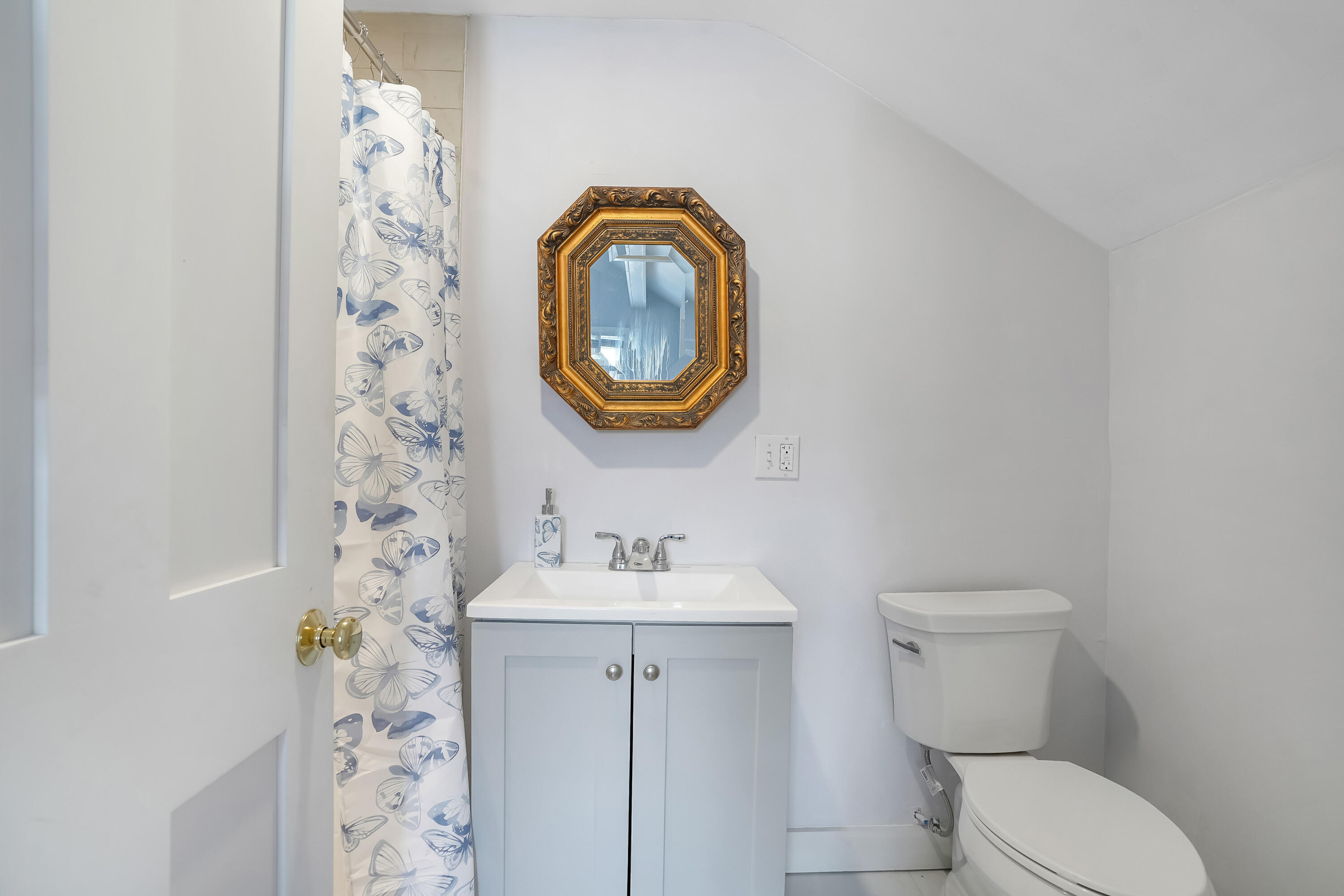 32 Norton Orchard Road Edgartown, MA 02539 - Photo 20 of 26 a bathroom with a toilet sink vanity and mirror