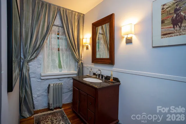 a bathroom with a granite countertop toilet a sink and a mirror