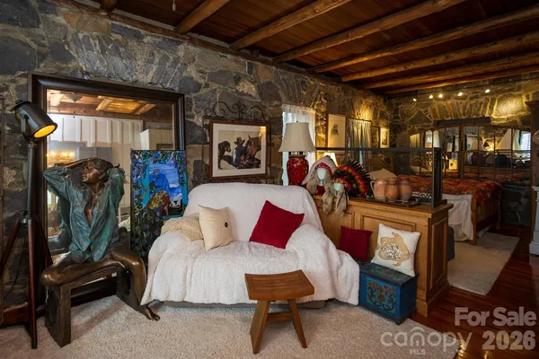 a living room with furniture a flat screen tv and windows