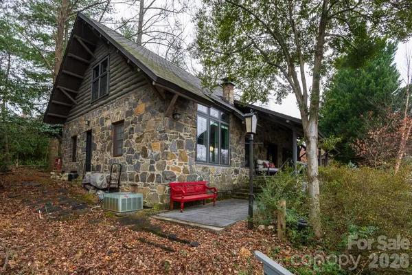 a backyard of a house with lots of green space and fountain