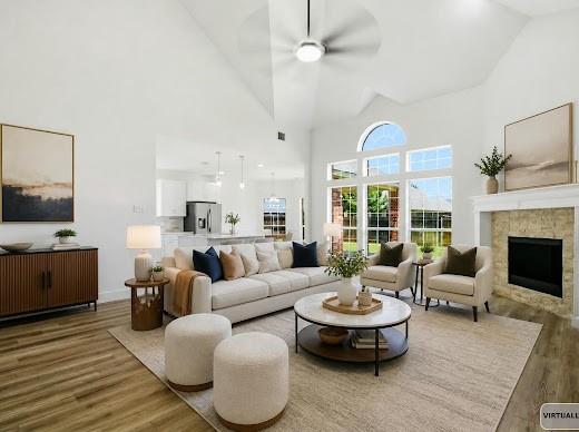 5034 West Fall Drive Midlothian, TX 76065 - Photo 10 of 40 Vaulted ceilings enhance this open-concept living space, featuring wood-finish flooring and a stone-clad fireplace with a classic mantel