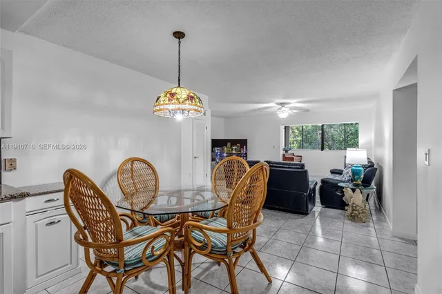 a dining room filled chandelier and wooden floor