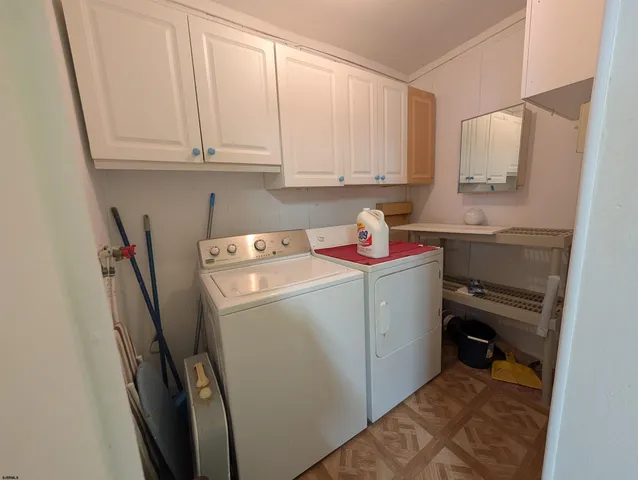a bedroom with a bed and a dresser next to a window