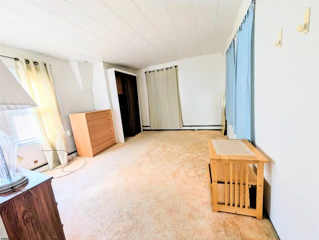 a bedroom with a bed and a desk